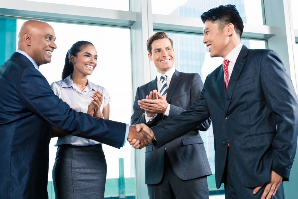 Business handshake in lofty office with city view, a deal is struck